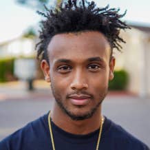 Young Ethiopian professional radiating joy after partnering with WubSites for their company's online branding.